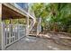 Outdoor living area with stairs leading up to the home with lush landscaping at 294 Kentucky Ave, Crystal Beach, FL 34681