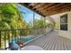 Covered balcony with views of the pool and surrounding tropical landscape at 294 Kentucky Ave, Crystal Beach, FL 34681
