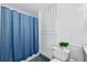 Cozy bathroom with a toilet and enclosed by a blue shower curtain at 294 Kentucky Ave, Crystal Beach, FL 34681