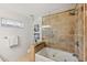 Bathroom featuring a tiled shower, soaking tub, and ample natural light at 294 Kentucky Ave, Crystal Beach, FL 34681