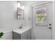Bathroom with a vessel sink, a mirror and a window on the door for extra daylight at 294 Kentucky Ave, Crystal Beach, FL 34681