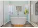Spa-like bathroom with freestanding tub, walk-in shower, and modern fixtures providing a relaxing retreat at 294 Kentucky Ave, Crystal Beach, FL 34681