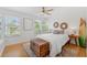 Well-lit bedroom featuring hardwood floors, multiple windows, and a surfboard at 294 Kentucky Ave, Crystal Beach, FL 34681