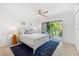 Bright bedroom featuring tile floors, blue rug, and balcony overlooking lush tropical landscape at 294 Kentucky Ave, Crystal Beach, FL 34681