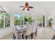 Bright dining area features neutral colors, tiled floor, and scenic backyard views at 294 Kentucky Ave, Crystal Beach, FL 34681
