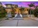 Stunning multi-story home with a grand staircase, lush landscaping, and dual garages at 294 Kentucky Ave, Crystal Beach, FL 34681