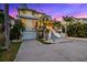 Beautiful multi-story home with lush tropical landscaping, front facing garages, and a grand entrance at 294 Kentucky Ave, Crystal Beach, FL 34681