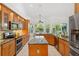 Spacious kitchen boasts stainless steel appliances, ample cabinet space, and a large island with granite countertop at 294 Kentucky Ave, Crystal Beach, FL 34681