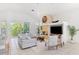 Bright living room featuring a stone fireplace, comfortable seating, and a view of the backyard at 294 Kentucky Ave, Crystal Beach, FL 34681