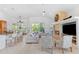 Open-concept living room with high ceilings, a stone fireplace, and bar seating at the kitchen island at 294 Kentucky Ave, Crystal Beach, FL 34681