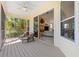 Relaxing screened-in patio featuring a view into the spacious living room with a fireplace at 294 Kentucky Ave, Crystal Beach, FL 34681