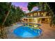 Stunning backyard with a private pool, spa, and a covered patio, perfect for outdoor entertaining at 294 Kentucky Ave, Crystal Beach, FL 34681