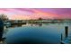 Scenic waterfront view with a calm blue canal reflecting the colorful homes and sky at 294 Kentucky Ave, Crystal Beach, FL 34681