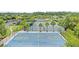 Overhead view of a blue outdoor basketball court with green accents, part of a community recreational area with tennis courts at 29737 Fog Hollow Dr, Wesley Chapel, FL 33543