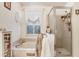 Cozy bathroom featuring a shower, a garden tub, and neutral walls at 29737 Fog Hollow Dr, Wesley Chapel, FL 33543