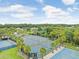 Aerial view of tennis courts and basketball courts, surrounded by lush trees, showcasing the community amenities at 29737 Fog Hollow Dr, Wesley Chapel, FL 33543
