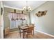 Cozy dining area with a chandelier, natural light, and seating for four at 29737 Fog Hollow Dr, Wesley Chapel, FL 33543