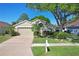 Charming one-story home features a two-car garage and lush landscaping at 29737 Fog Hollow Dr, Wesley Chapel, FL 33543
