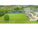 Aerial view of the playground and recreational area featuring green space, playground equipment, and shaded seating at 29737 Fog Hollow Dr, Wesley Chapel, FL 33543