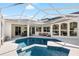 A private backyard features a screened-in pool with a spa, dining area and seating at 30247 Fairway Dr, Wesley Chapel, FL 33543