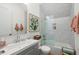 Modern bathroom features a tub/shower combo, a gray vanity, and decorative tiling at 30247 Fairway Dr, Wesley Chapel, FL 33543