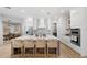 Bright kitchen features an island with seating, modern appliances, and white cabinetry at 30247 Fairway Dr, Wesley Chapel, FL 33543