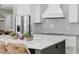 A kitchen island has ample countertop space, a sink, and views of the stovetop and refrigerator at 30247 Fairway Dr, Wesley Chapel, FL 33543