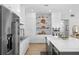 Open kitchen with white cabinets, stainless steel appliances, and a large center island at 30247 Fairway Dr, Wesley Chapel, FL 33543