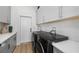 A bright and modern laundry room featuring a new washer and dryer, cabinets and sink at 30247 Fairway Dr, Wesley Chapel, FL 33543