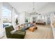 Open living area boasts vaulted ceilings, large windows, and seamless flow to the kitchen at 30247 Fairway Dr, Wesley Chapel, FL 33543