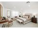 Well-lit bedroom boasts neutral tones, stylish decor, accent lighting, and a cozy seating area at 30247 Fairway Dr, Wesley Chapel, FL 33543