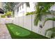 Landscaped backyard with a putting green and a privacy fence, offering a perfect space for recreation at 3325 W Wallcraft Ave, Tampa, FL 33611