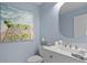 Charming bathroom features a modern vanity, stylish mirror, and beach-themed artwork for a relaxing atmosphere at 3325 W Wallcraft Ave, Tampa, FL 33611