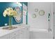 Elegant bathroom features a double vanity, stylish mirrors, and a soaking tub for a spa-like experience at 3325 W Wallcraft Ave, Tampa, FL 33611