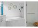 Bright bathroom with a soaking tub, glass enclosed shower, and modern fixtures at 3325 W Wallcraft Ave, Tampa, FL 33611