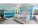 This stylish bedroom boasts bright blue walls, white trim, and curtains next to two windows at 3325 W Wallcraft Ave, Tampa, FL 33611