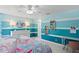 A fun mermaid-themed bedroom with bright blue walls, white trim, and ample storage at 3325 W Wallcraft Ave, Tampa, FL 33611