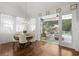 Bright dining area with hardwood floors, stylish lighting, and access to a screened outdoor patio and pool at 3325 W Wallcraft Ave, Tampa, FL 33611