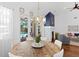 Dining room showcasing a decorative fireplace, pool view, and access to the outdoors at 3325 W Wallcraft Ave, Tampa, FL 33611