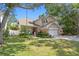 Charming two-story home with well-manicured lawn, mature trees, and a cozy front porch seating area at 3325 W Wallcraft Ave, Tampa, FL 33611