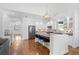Spacious open kitchen featuring a central island with bar seating, stainless appliances, and modern lighting at 3325 W Wallcraft Ave, Tampa, FL 33611