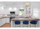 Bright white kitchen with stainless steel appliances, marble backsplash, and a beautiful wooden island with seating at 3325 W Wallcraft Ave, Tampa, FL 33611