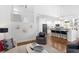 Open-concept living area with stairs, an island kitchen, and stylish decor creating an inviting atmosphere at 3325 W Wallcraft Ave, Tampa, FL 33611