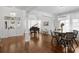 Bright living room featuring hardwood floors, elegant chandeliers, a piano, and stylish decor for sophisticated living at 3325 W Wallcraft Ave, Tampa, FL 33611