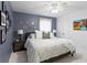 Cozy main bedroom with a bed, nightstands, and decorative artwork creating a comfortable atmosphere at 3325 W Wallcraft Ave, Tampa, FL 33611