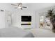 Modern main bedroom with large-screen TV, white and gray color palette and patio access at 3325 W Wallcraft Ave, Tampa, FL 33611