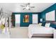 Bright main bedroom featuring a ceiling fan, stylish decor, a balcony, and ample natural light at 3325 W Wallcraft Ave, Tampa, FL 33611