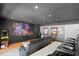 Home theater room featuring a large projection screen, comfortable seating, and unique decor at 3325 W Wallcraft Ave, Tampa, FL 33611