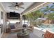 Screened-in patio with ceiling fan, seating area, and views of the pool and lush landscaping at 3325 W Wallcraft Ave, Tampa, FL 33611