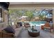 Covered patio with stylish seating, a ceiling fan, and views of the pool at 3325 W Wallcraft Ave, Tampa, FL 33611